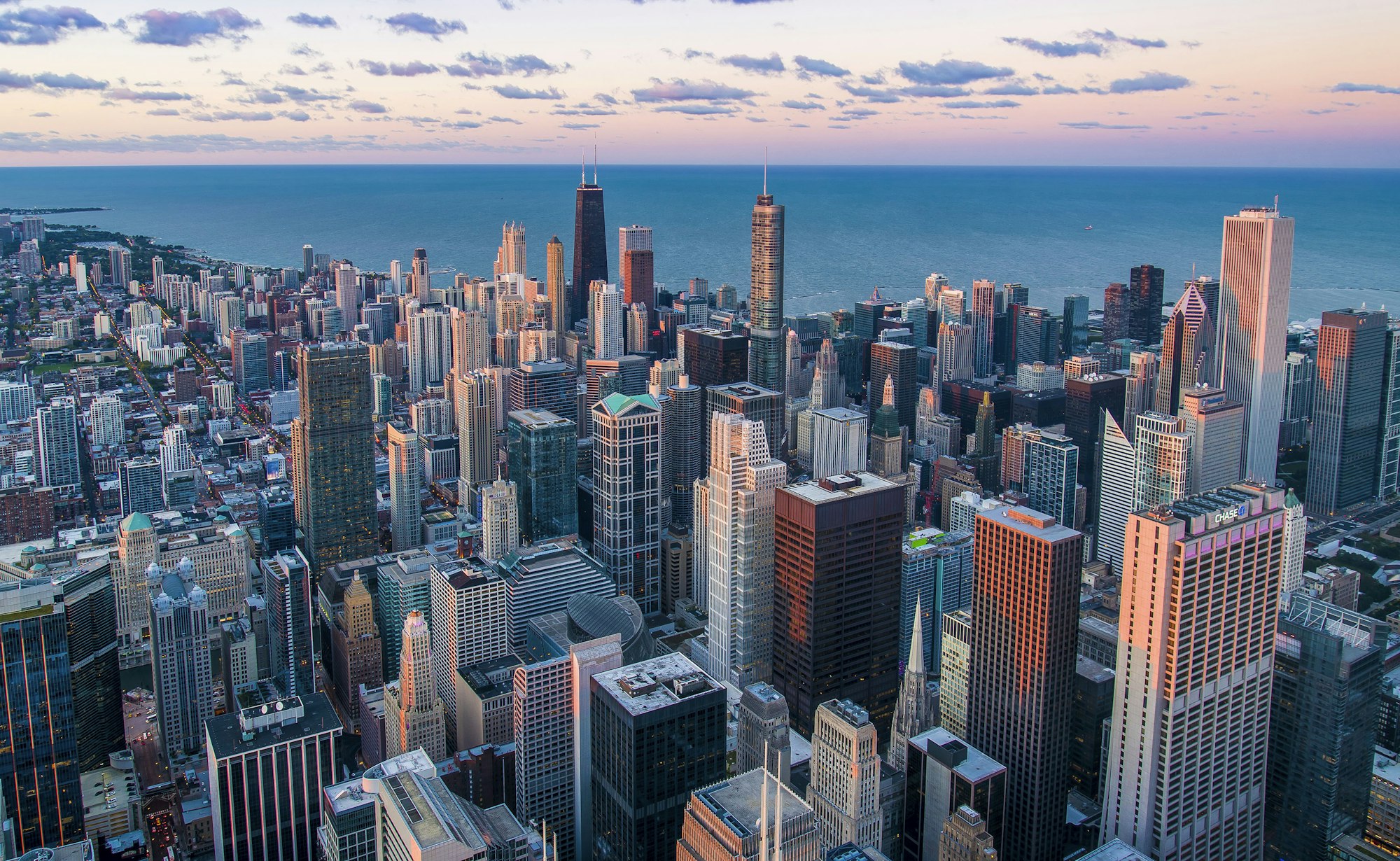 A coastal city at dusk, seen from above